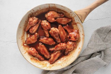 Toss chicken wings in sauce