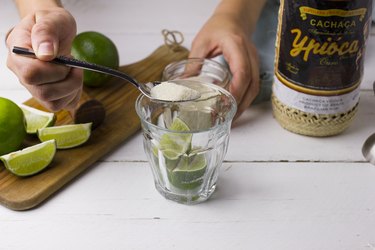 Pouring sugar over lines in a cocktail glass