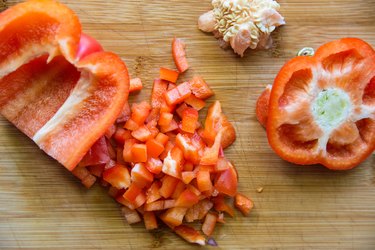 Chopped red bell pepper on a cutting board.