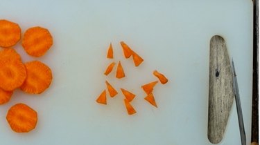 Cutting beaks from carrot chips for deviled egg Easter chicks.