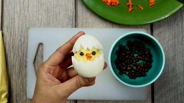 Assembling deviled egg Easter chicks.