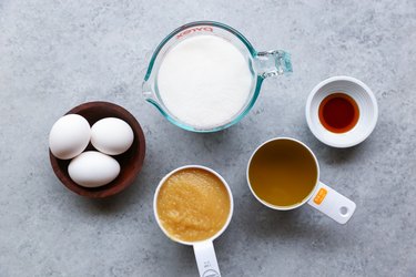 Measuring cups of wet ingredients for carrot cake