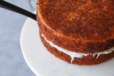 Placing the second cake on top of the first