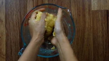 Mixing ingredients with hands for almond flour no-roll gluten-free low-carb pie crust.