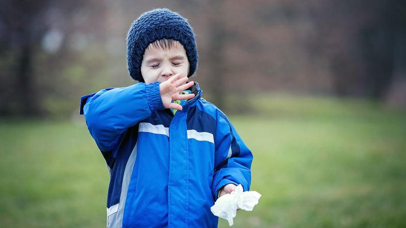 boy sneezing